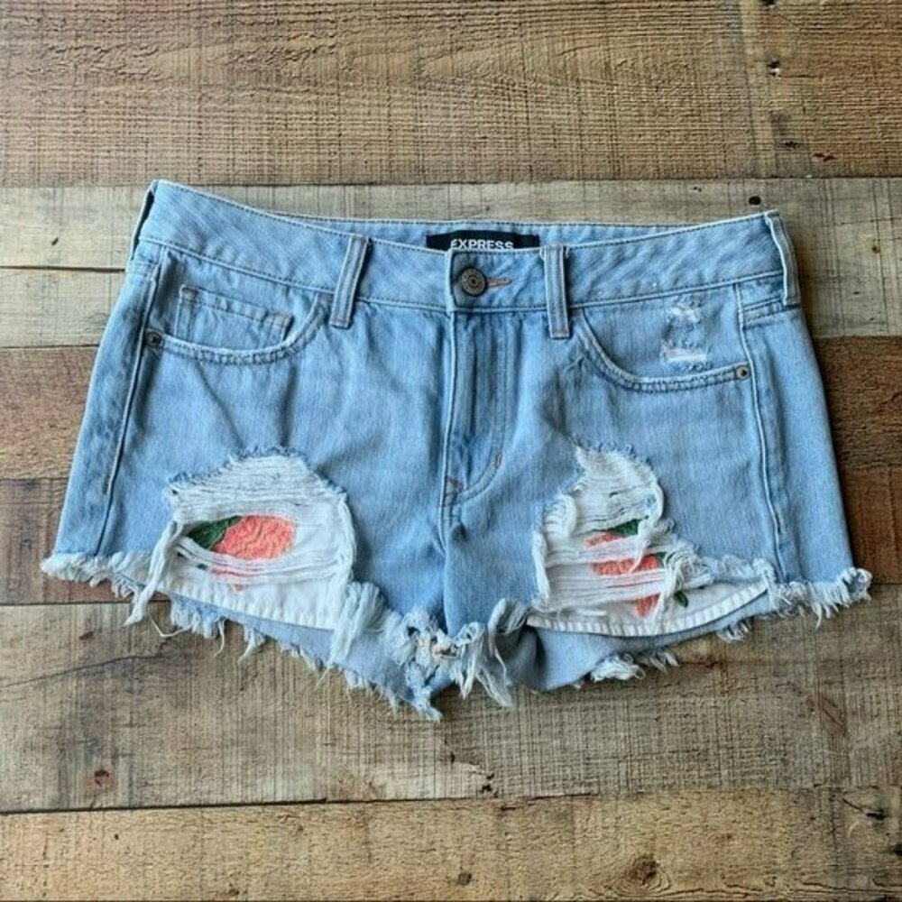 Express low rise denim shorts with peel a boo embroidered flowers on the pockets